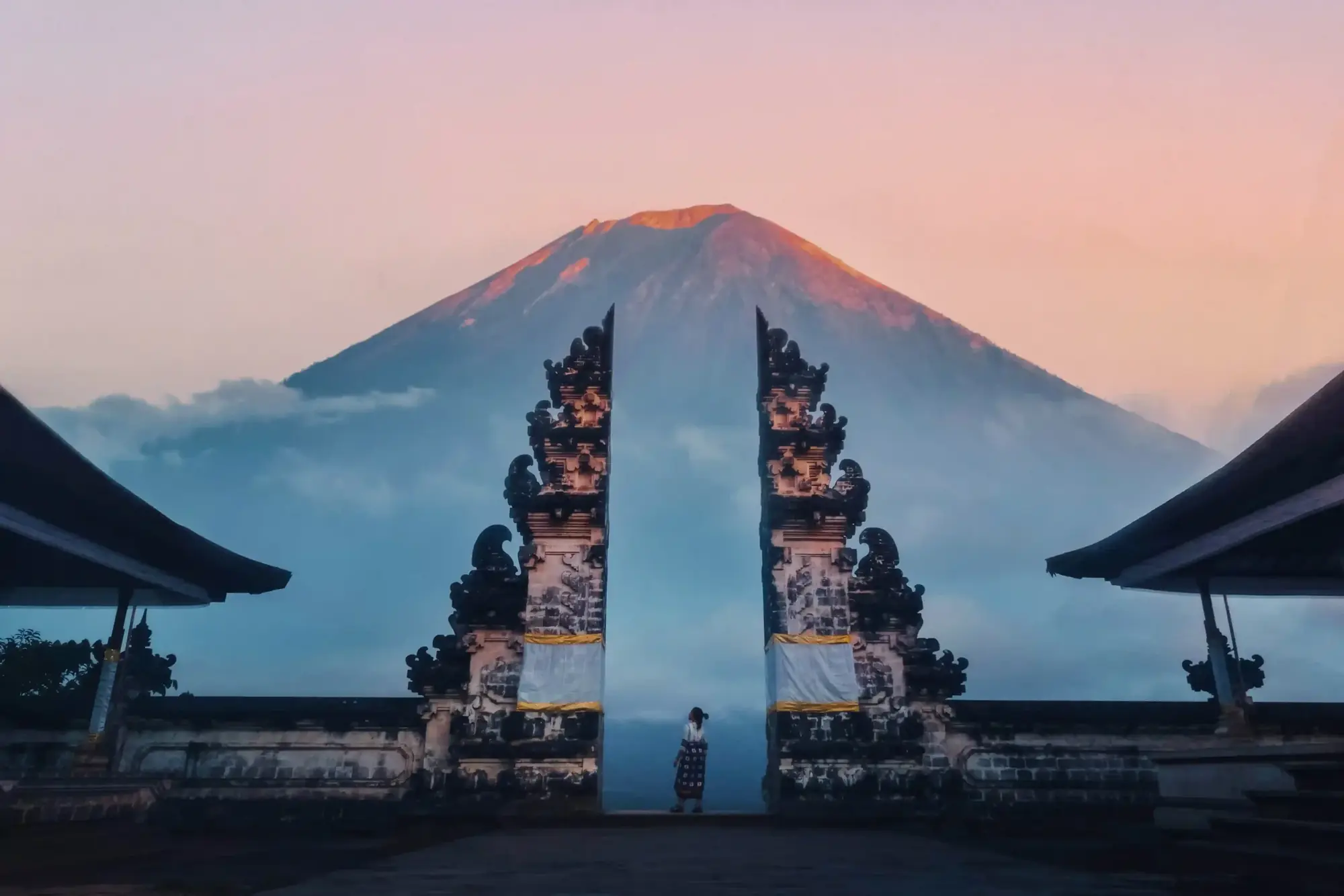 Bali temple gateway framing a volcano at dawn