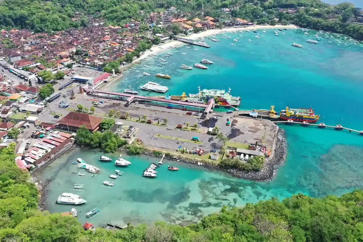 Aerial view of Padang Bai harbour with ferries and boats in a turquoise bay