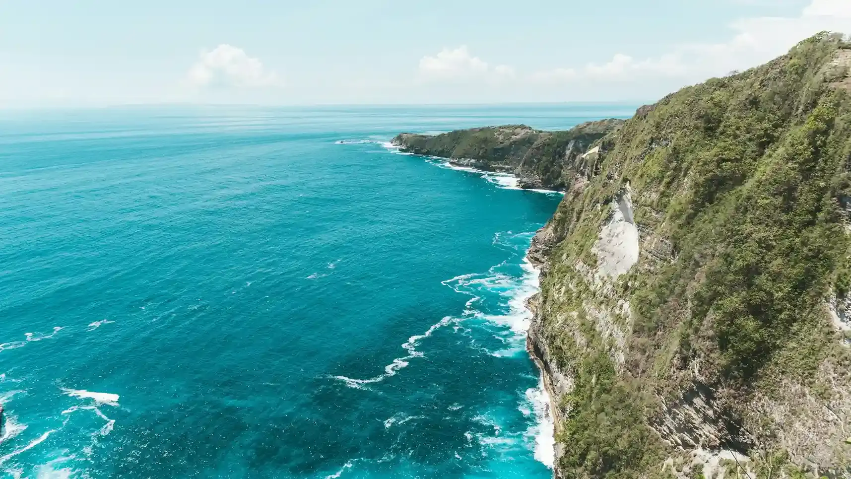 Turquoise sea meeting the green cliffs of Nusa Penida